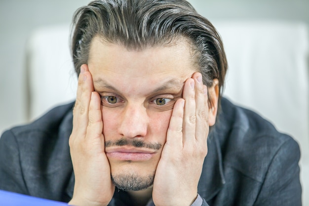 Young businessman working from his office  - the concept of failure