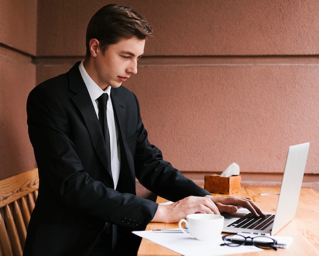 Young businessman working on laptop