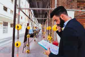 Free photo young businessman working and talking on the phone