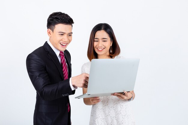 Young businesspeople working with laptop on white 