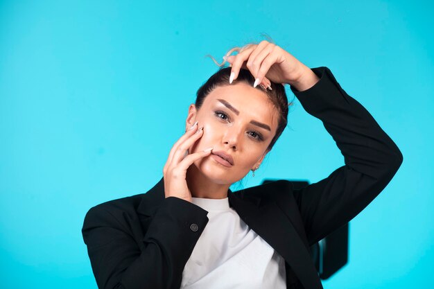 Young businesswoman in black blazer, front view.