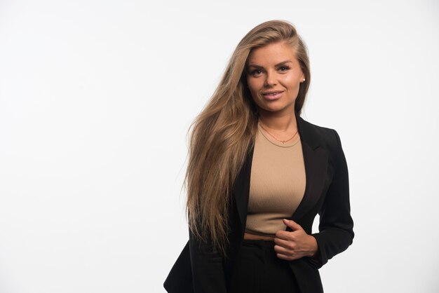 Young businesswoman in black suit looks confident and professional. 