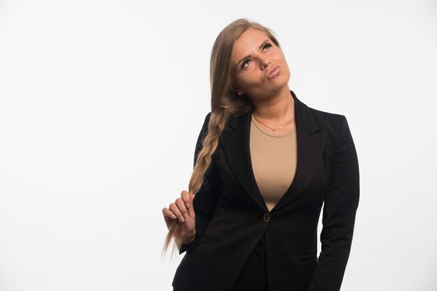 Young businesswoman in black suit looks confident.