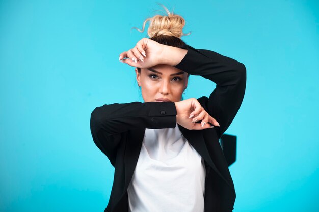 Young businesswoman in bun wearing black blazer. 