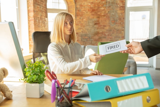 Young businesswoman fired, looks upset