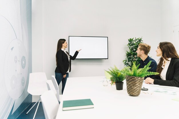 young businesswoman giving presentation in office