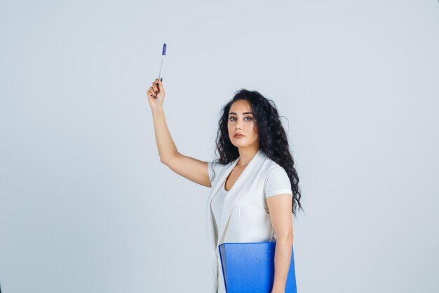 Young businesswoman holding a blue file folder