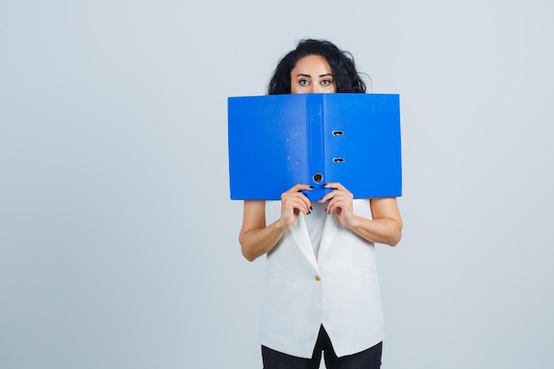 Young businesswoman holding a blue file folder