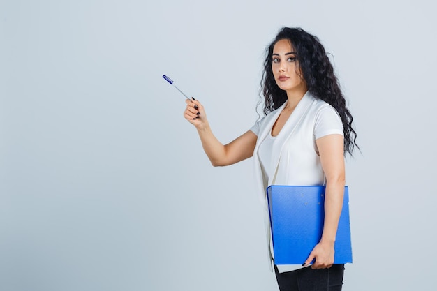 Young businesswoman holding a blue file folder