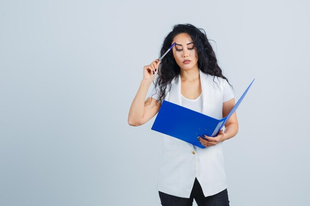 Young businesswoman holding a blue file folder