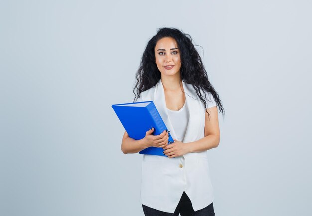 Young businesswoman holding a blue file folder