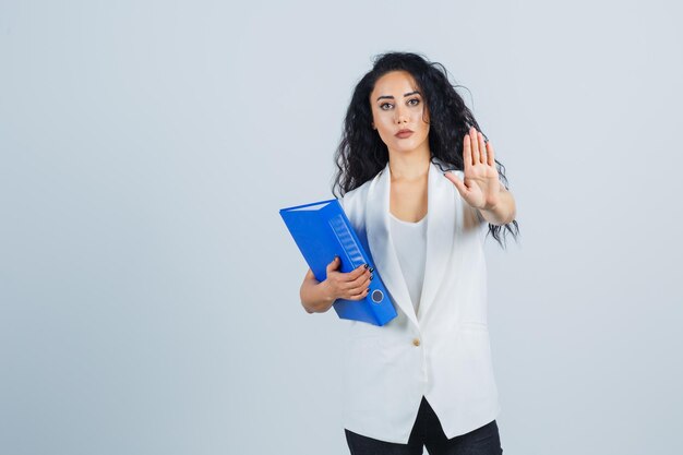 Young businesswoman holding a blue file folder