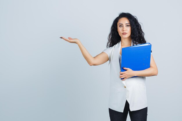 Young businesswoman holding a blue file folder