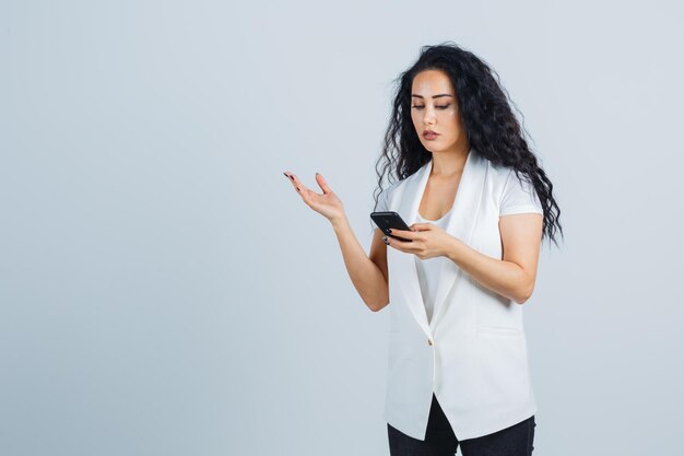 Young businesswoman holding a phone