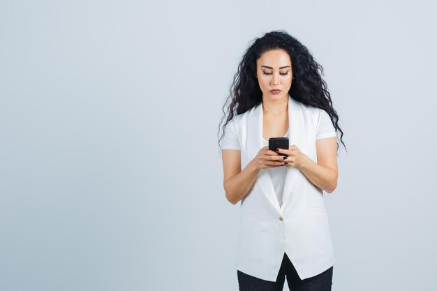 Young businesswoman holding a phone