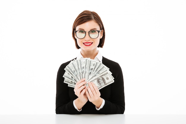 Young businesswoman showing money