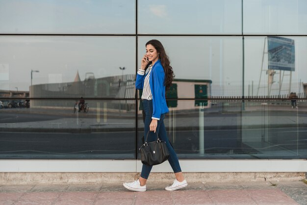 Young businesswoman talking on the phone and smiling