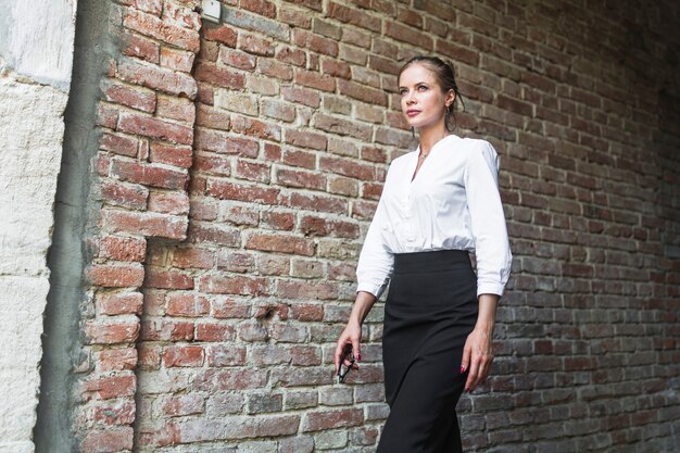 Free photo young businesswoman walking in tunnel