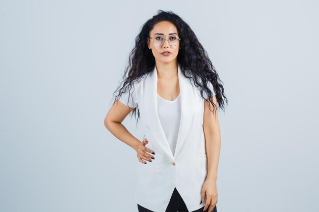 Young businesswoman in a white jacket with eyeglasses