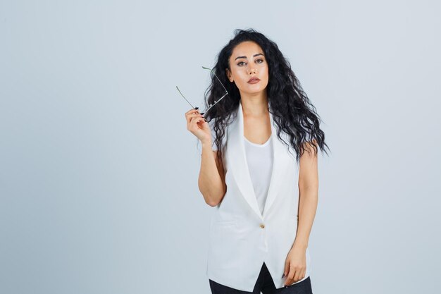 Young businesswoman in a white jacket with eyeglasses