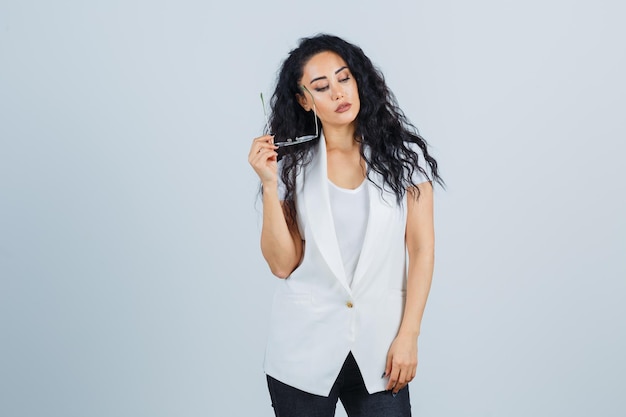 Young businesswoman in a white jacket with eyeglasses