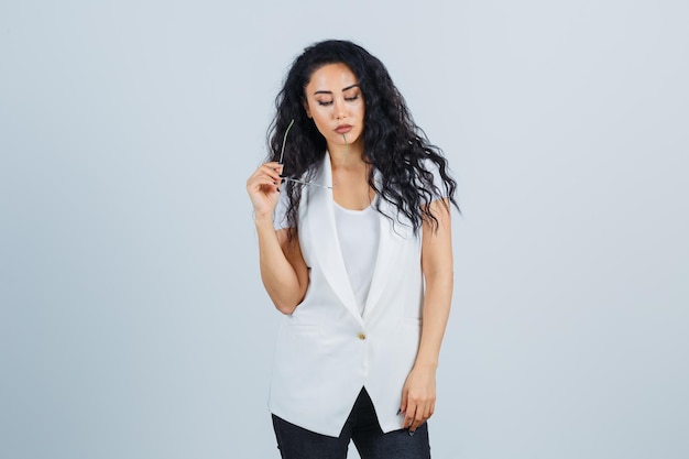 Young businesswoman in a white jacket with eyeglasses