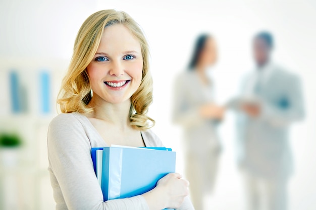 Young businesswoman with co-workers blurred background