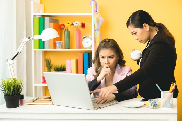 young businesswomen talking chatting in office