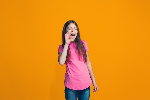 Young casual girl shouting at studio