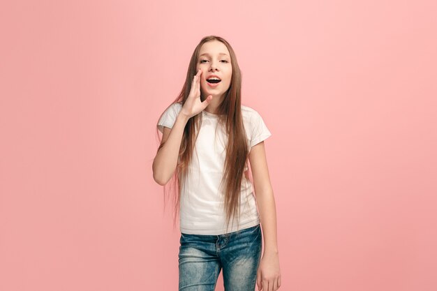 young casual teen girl shouting on pink