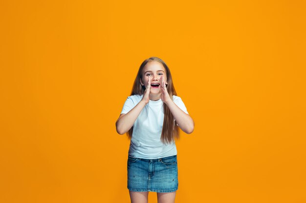 Young casual teen girl shouting