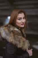 Free photo young caucasian female with brown hair wearing a black coat