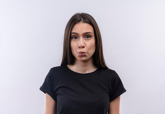 young caucasian girl wearing black t-shirt showing kiss gesture on isolated white wall