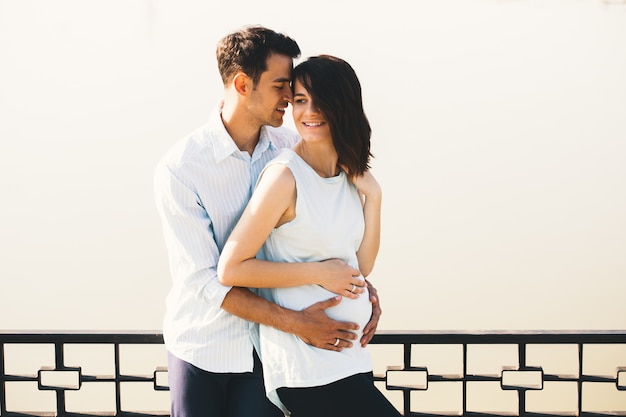 Young Caucasian Man Hugging Pregnant Wife