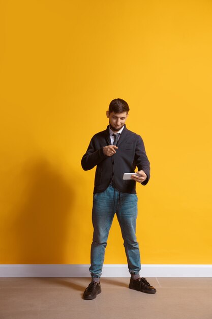 Young caucasian man using smartphone, serfing, chatting, betting.