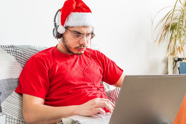 Young Caucasian man working from home during Christmas season
