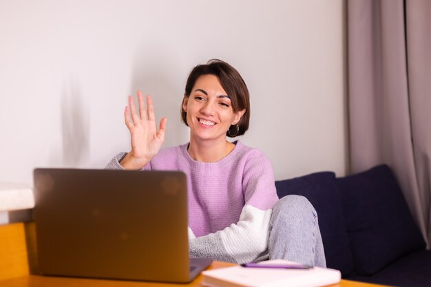 Young caucasian smile girl woman in bedroom on sofa smile camera