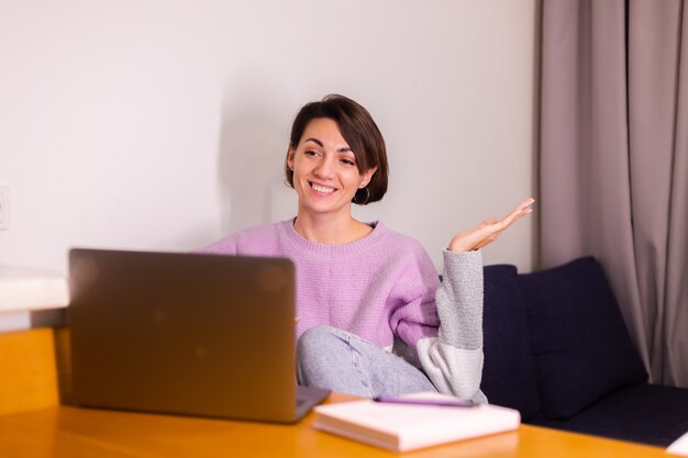 Young caucasian smile girl woman in bedroom on sofa smile camera