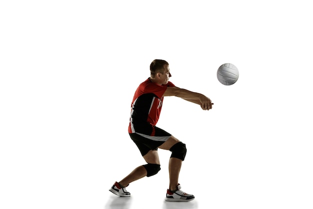 Young caucasian volleyball player placticing isolated on white background.
