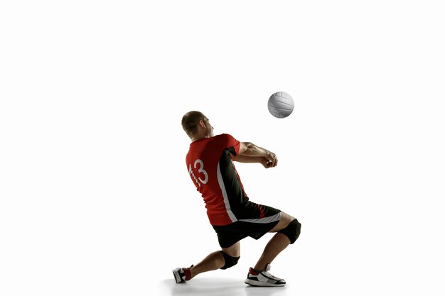 Young caucasian volleyball player placticing isolated on white background