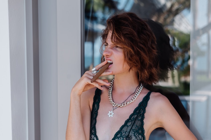 Free Photo young caucasian woman in hotel room in underwear with cigar.