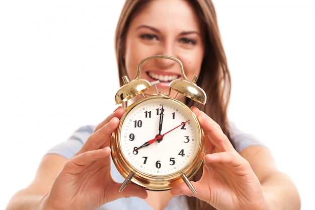 Young caucasian woman with alarm clock