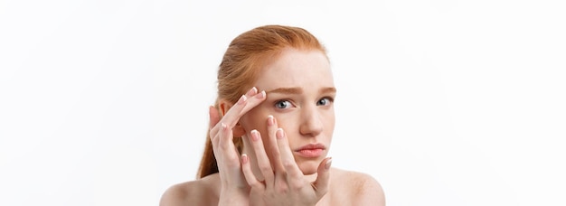 Free photo young caucsian woman squeezes acne on the face of beauty