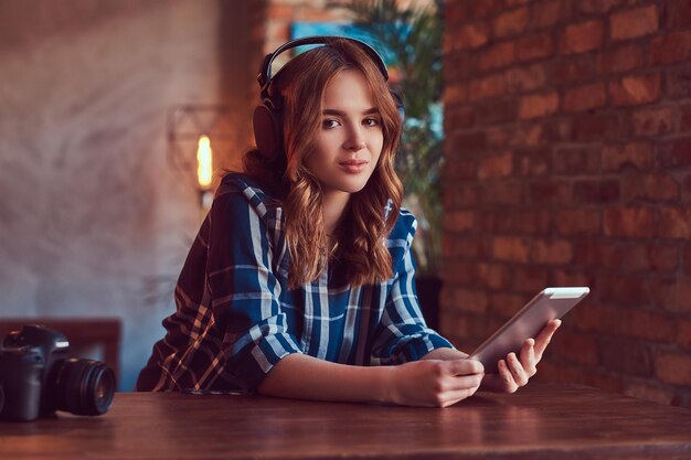 A young charming sensual girl listening to a music in headphones