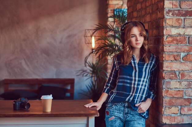 A young charming sensual girl listening to a music in headphones