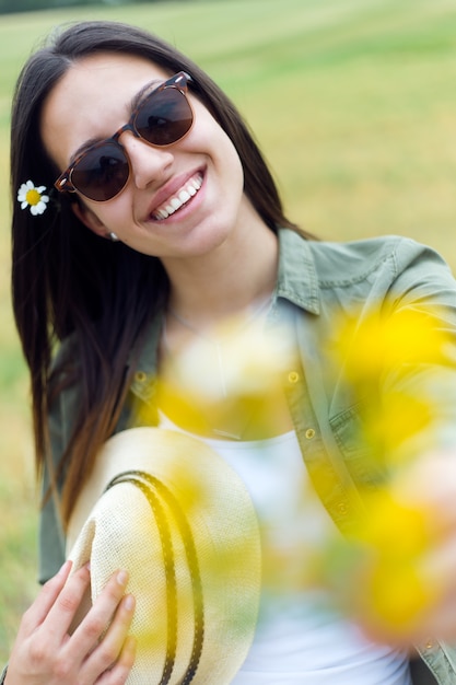 Free photo young cheerful female with meadow flowers