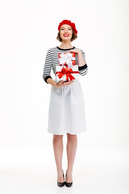 Young cheerful woman holding gift surprise box.