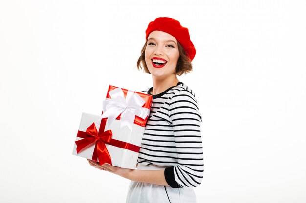 Young cheerful woman holding gift surprise box.