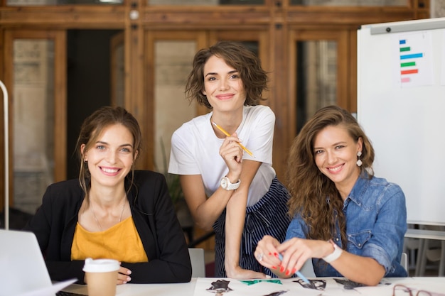 Young cheerful women happily looking in camera while spending ti