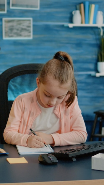 Young child doing homework with mother for remote education